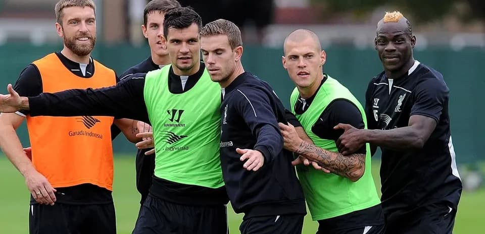 Liverpool players training and interacting on the pitch