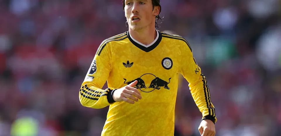 Player wearing yellow jersey running on the field