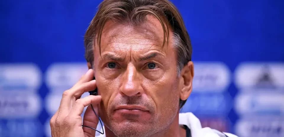 Coach speaking into headset during press conference
