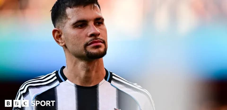 Newcastle player in black and white jersey