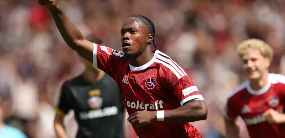 Player celebrating goal during match in red jersey