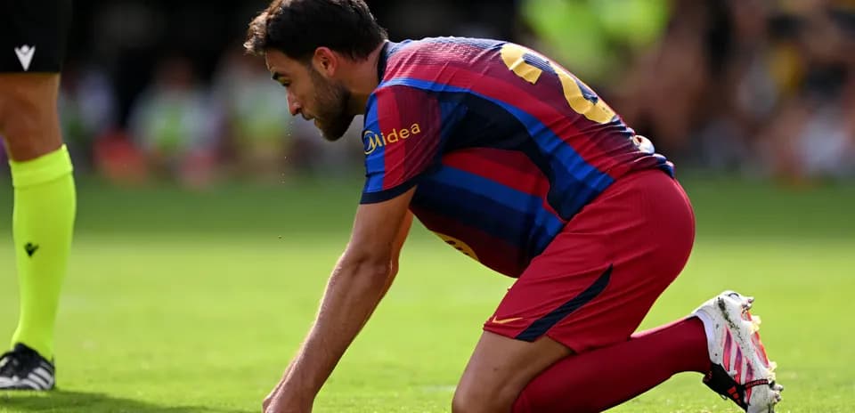 Player kneeling on pitch during match action