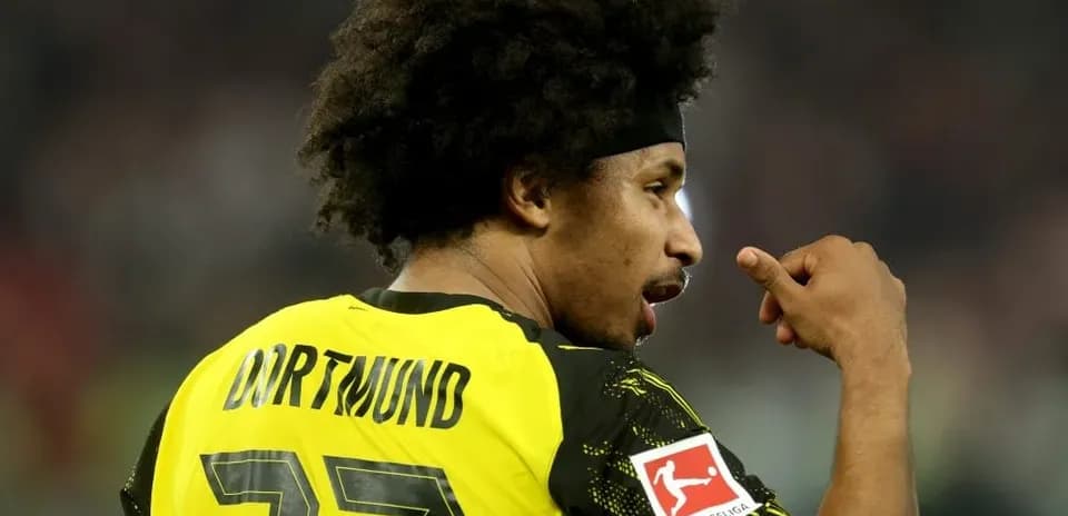 Player in Borussia Dortmund jersey celebrating on field