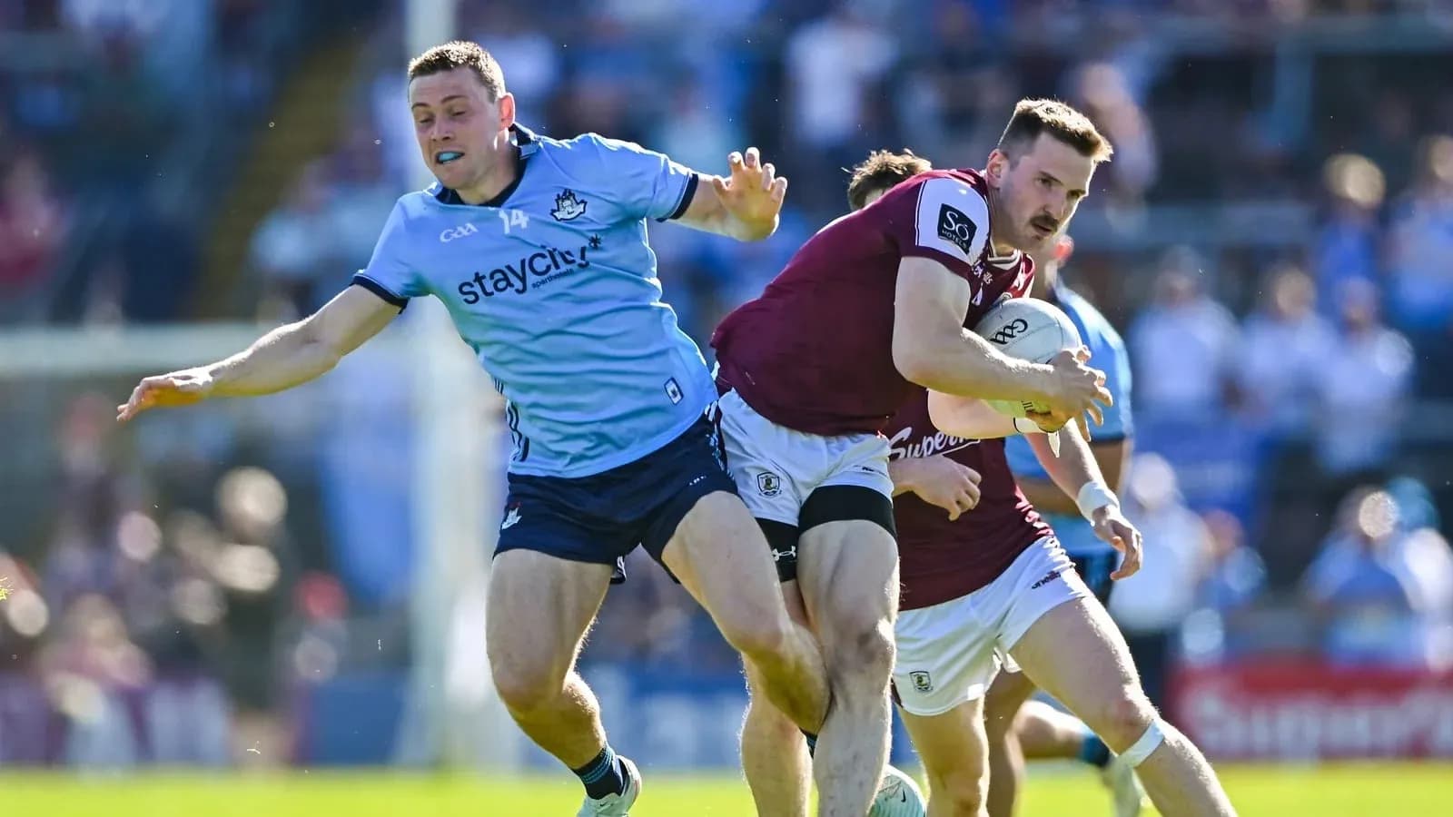 Player tackling opponent while holding the ball