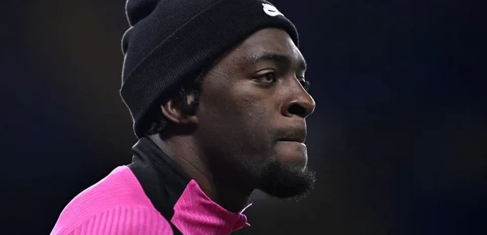 Player wearing pink training top and black beanie
