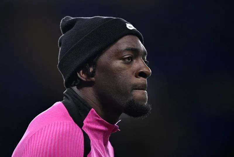 Player wearing pink training top and black beanie