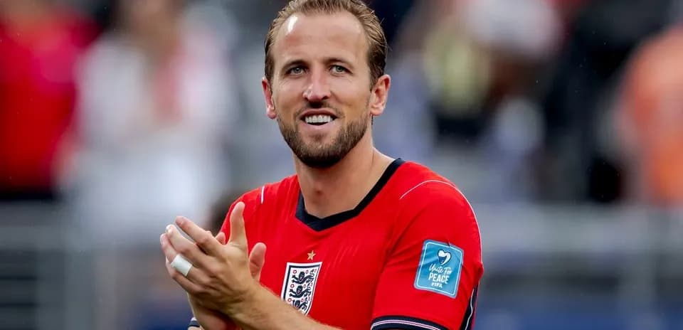 Player applauding wearing red jersey during match