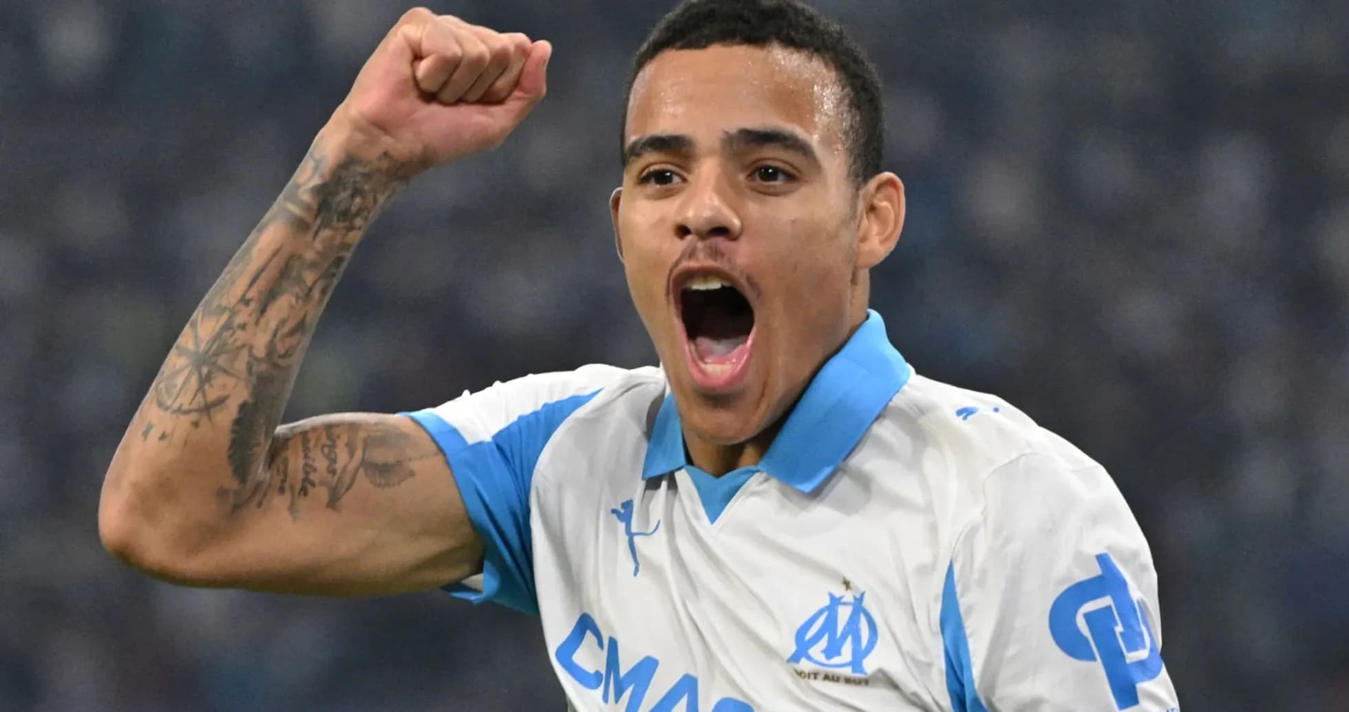 Player celebrating a goal wearing Marseille jersey