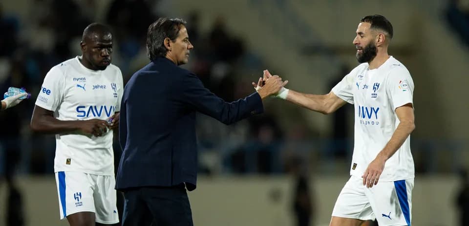 Coach shaking hands with player on the field