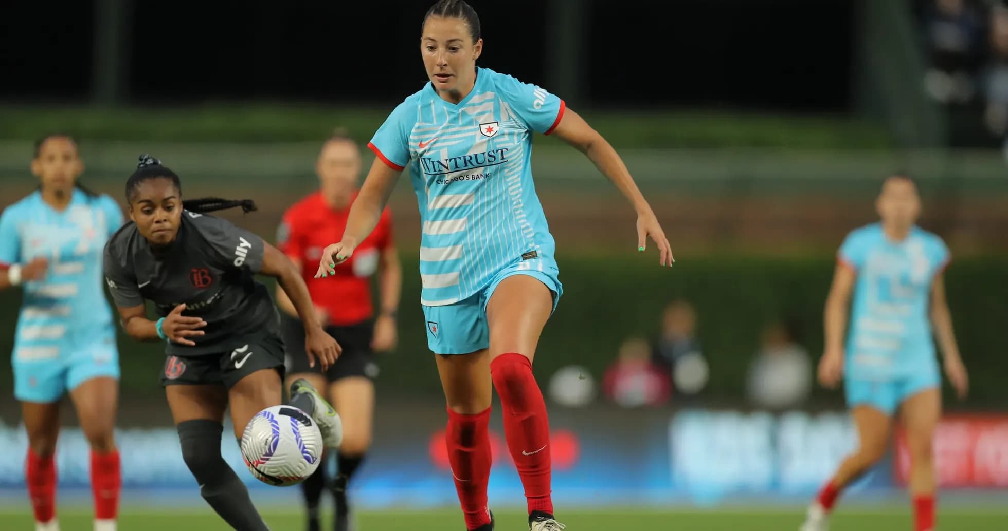 Players competing for the ball during match