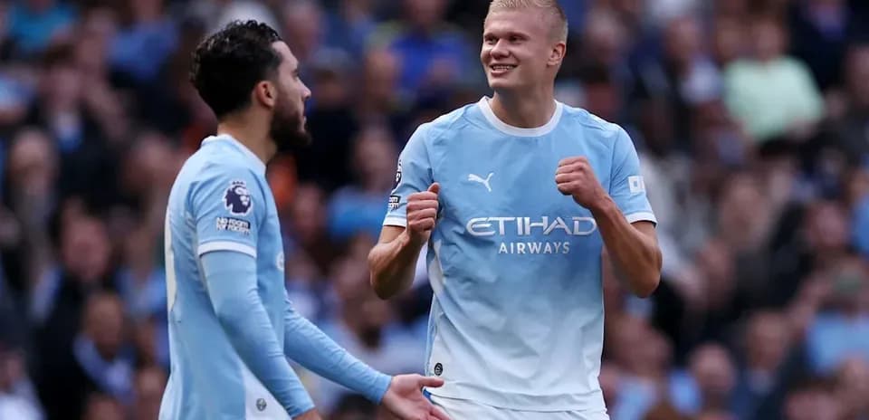 Manchester City players celebrating a goal together
