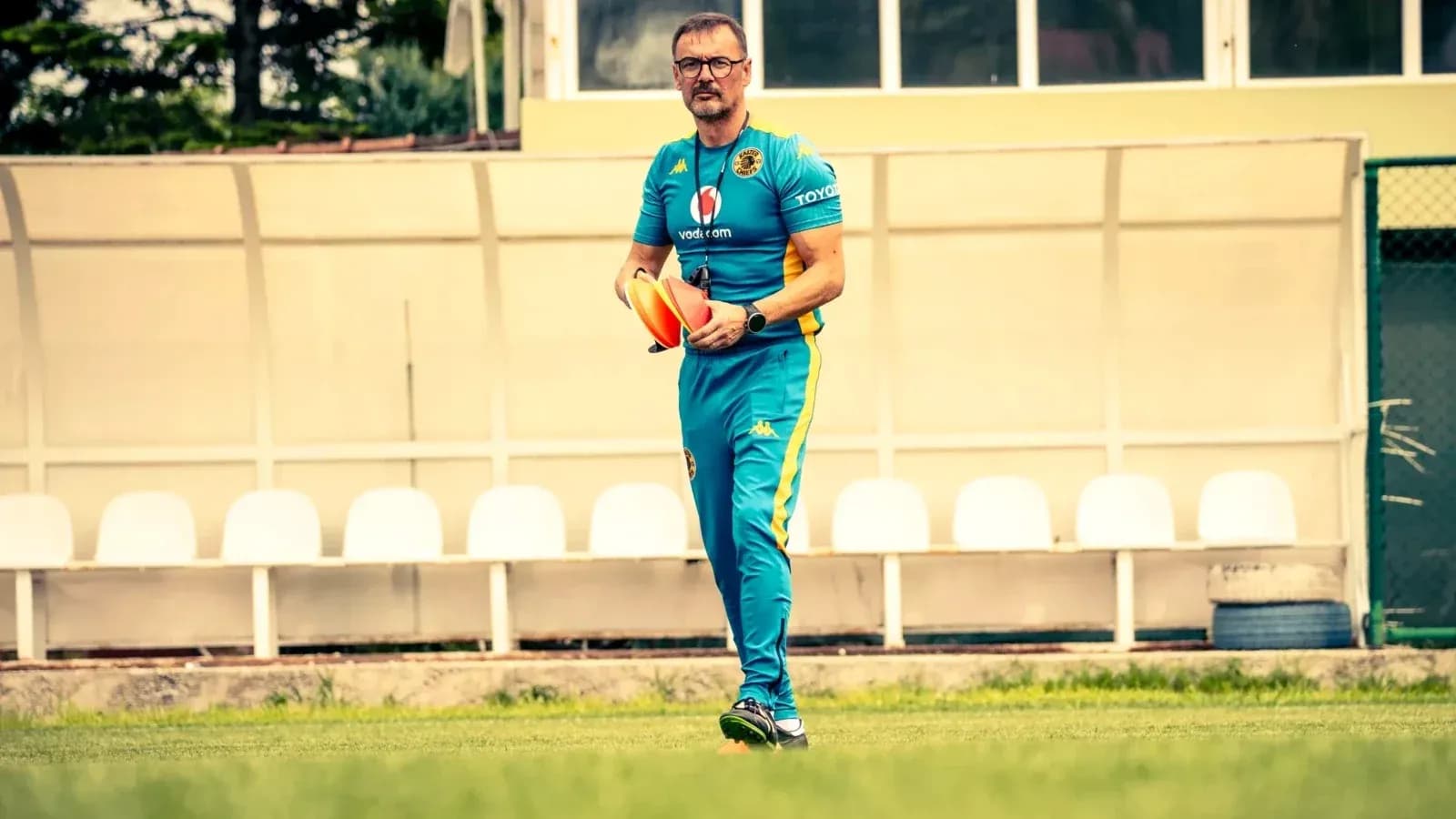 Coach holding training cones on the field