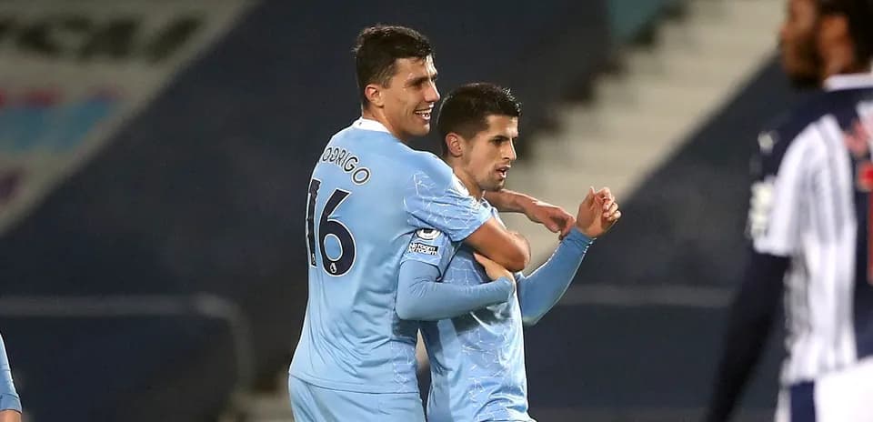 Players celebrating a goal on the pitch