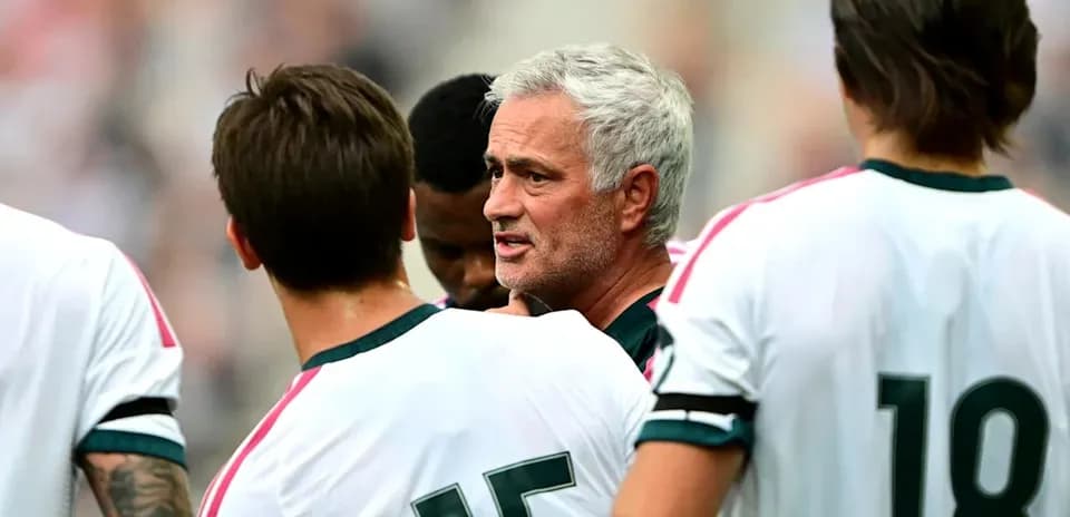 Manager discussing strategy with players during match