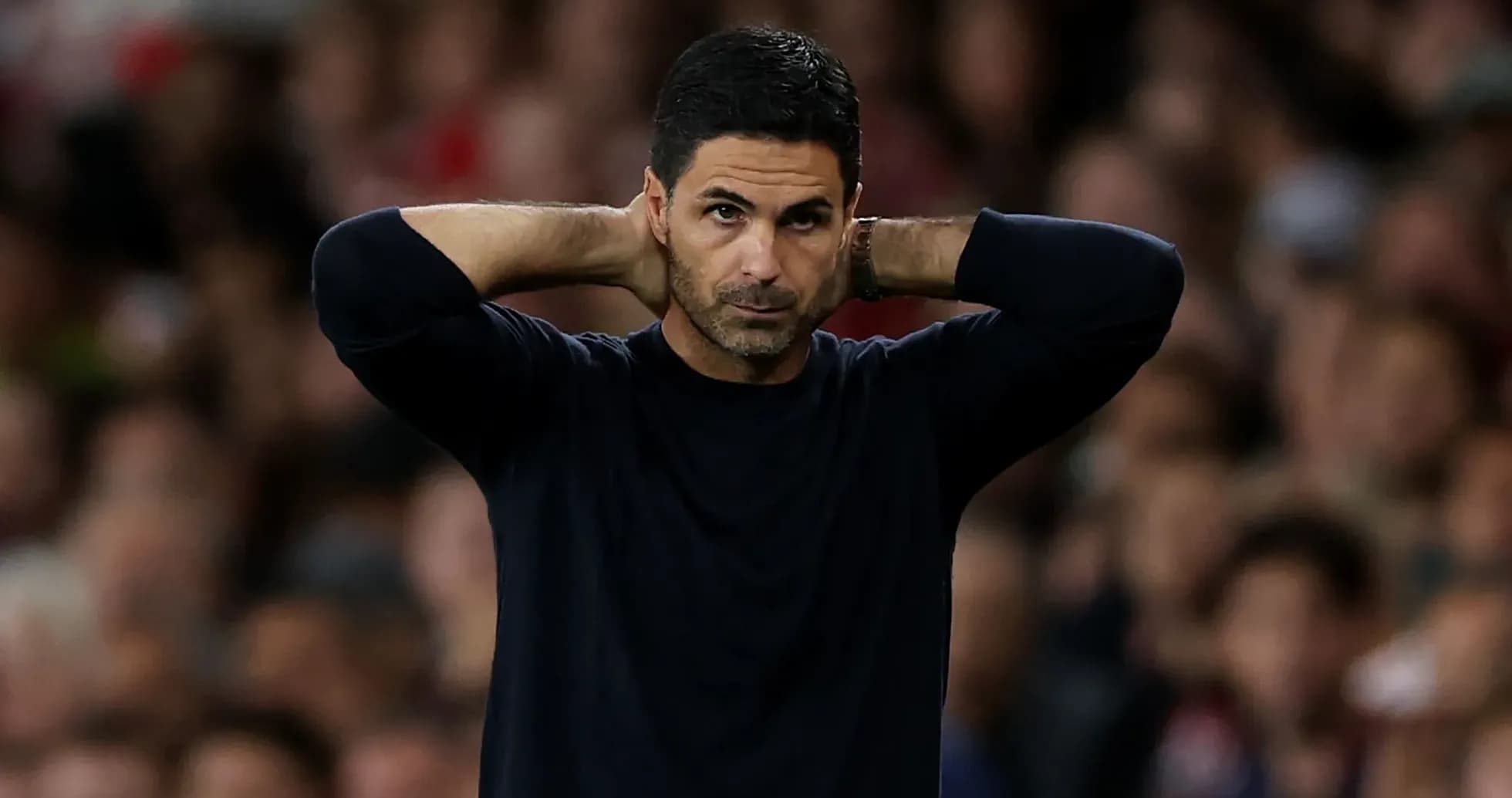 Coach with hands on head during match