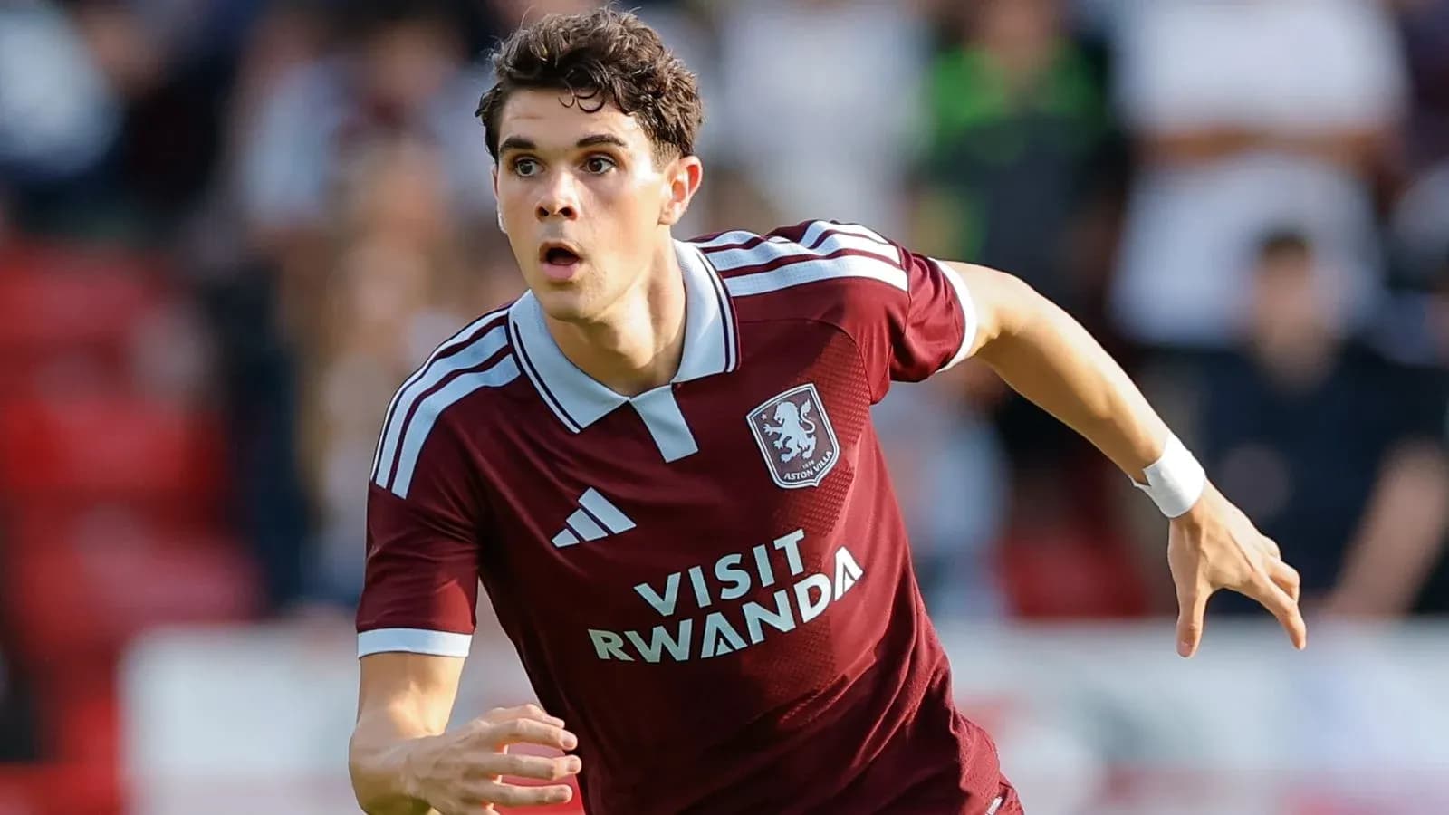 Player sprinting in Aston Villa kit during match