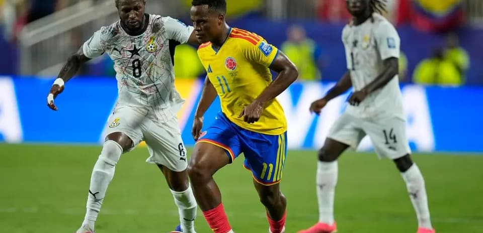 Colombian player dribbling past Ghanaian defender during match