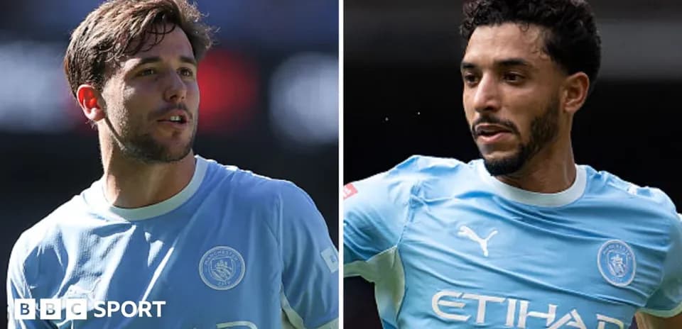 Two Manchester City players in light blue kits