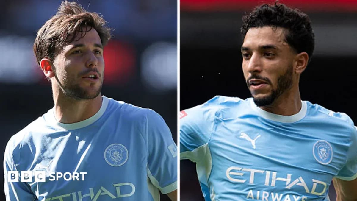 Two Manchester City players in light blue kits