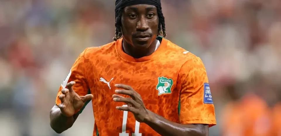 Player warming up in orange jersey on field