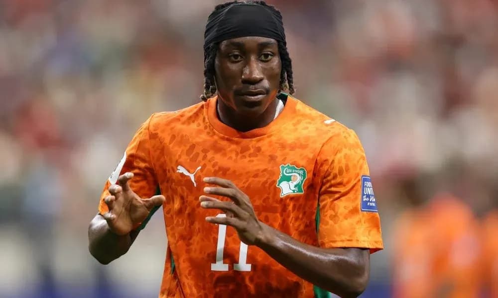Player warming up in orange jersey on field