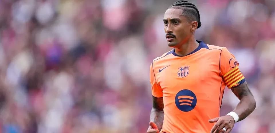 Player in orange Barcelona kit running on pitch