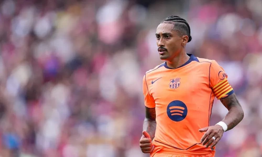 Player in orange Barcelona kit running on pitch