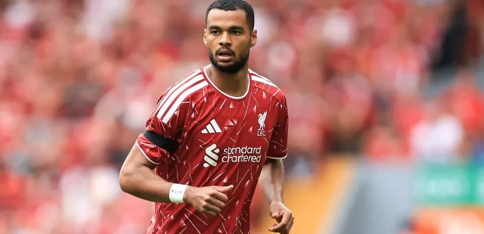 Player in Liverpool kit during match warm-up