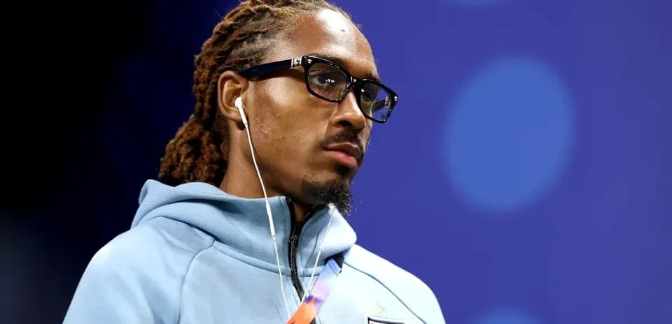 Player wearing glasses and headphones in team hoodie