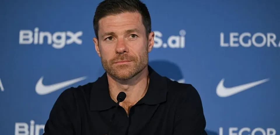 Manager at press conference with microphone and backdrop