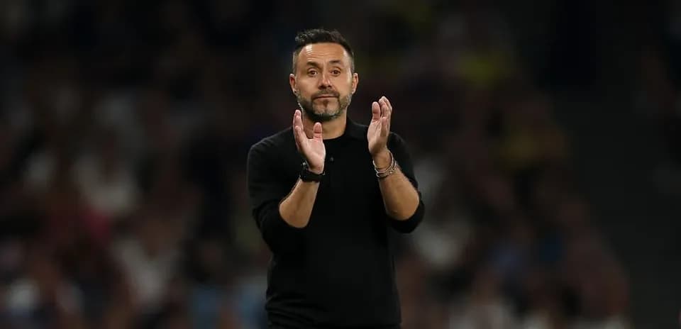 Coach applauding during a match on the sideline
