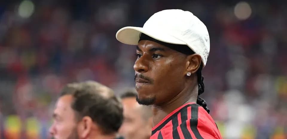 Player in red jersey observing the match