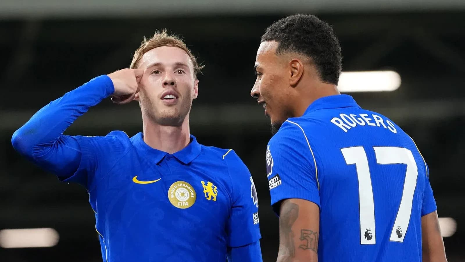 Two Chelsea players celebrating a goal on pitch