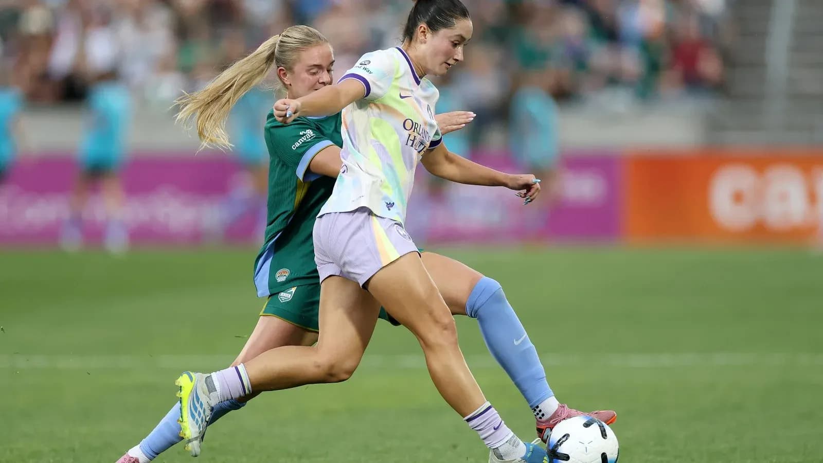 Orlando Pride player dribbling past Bay FC opponent