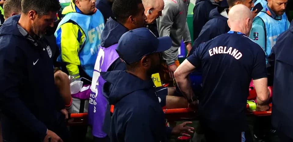 Medical staff assisting player off the field