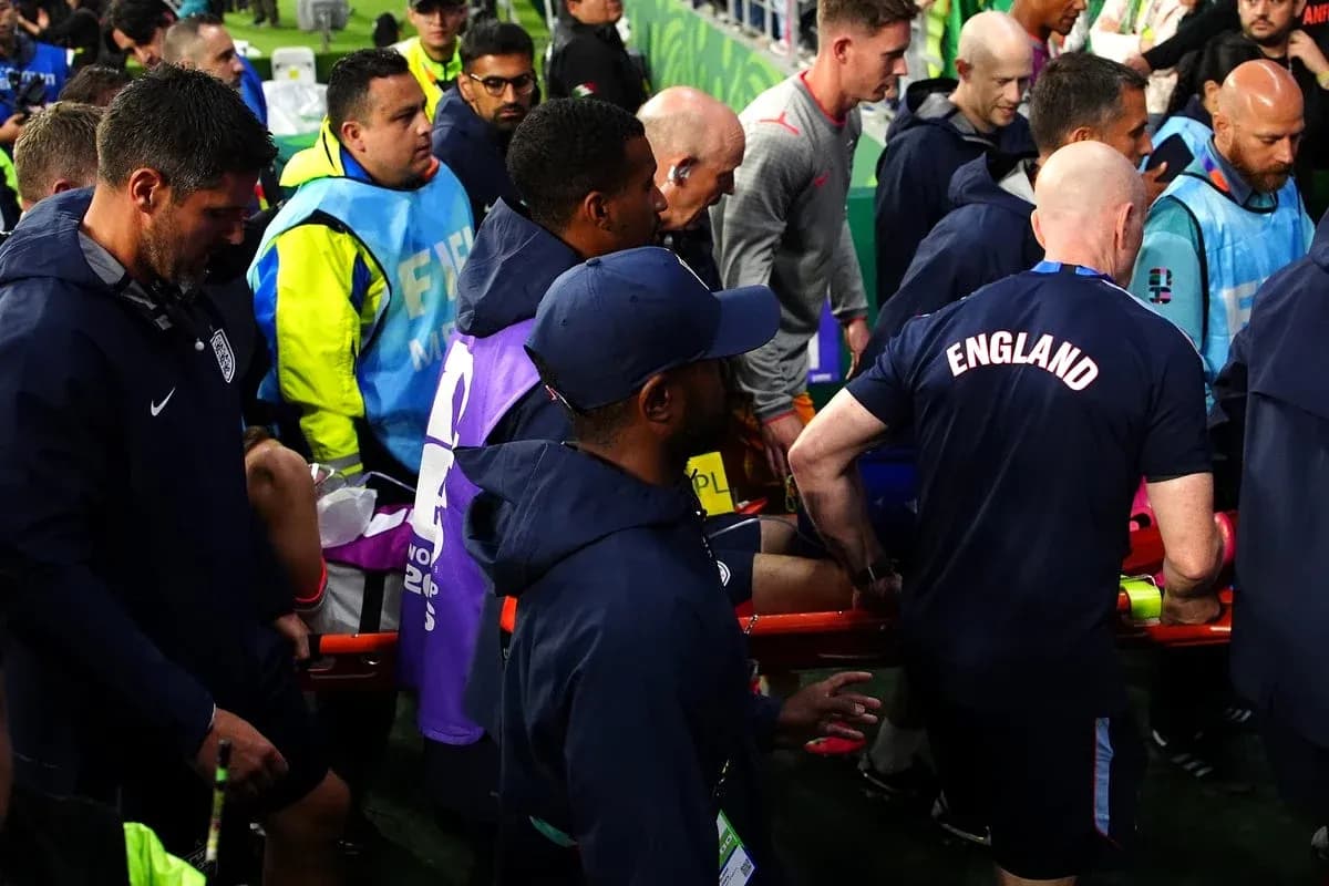 Medical staff assisting player off the field