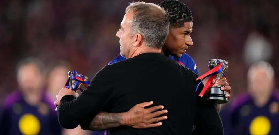 Player receiving award and hugging coach on field