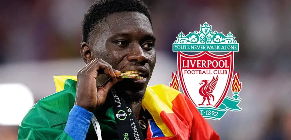 Player holding gold medal wearing national flag