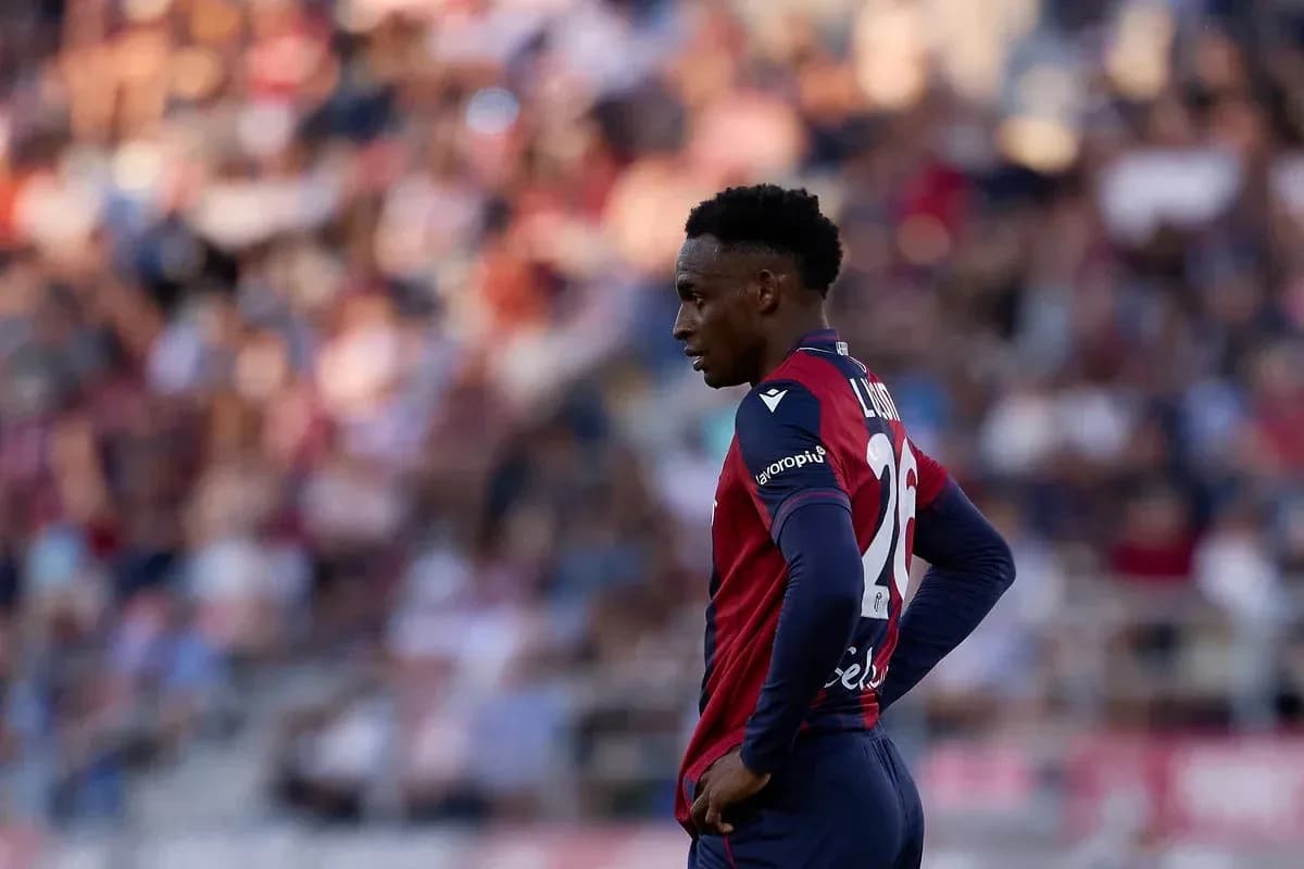Player in red and blue kit on the field