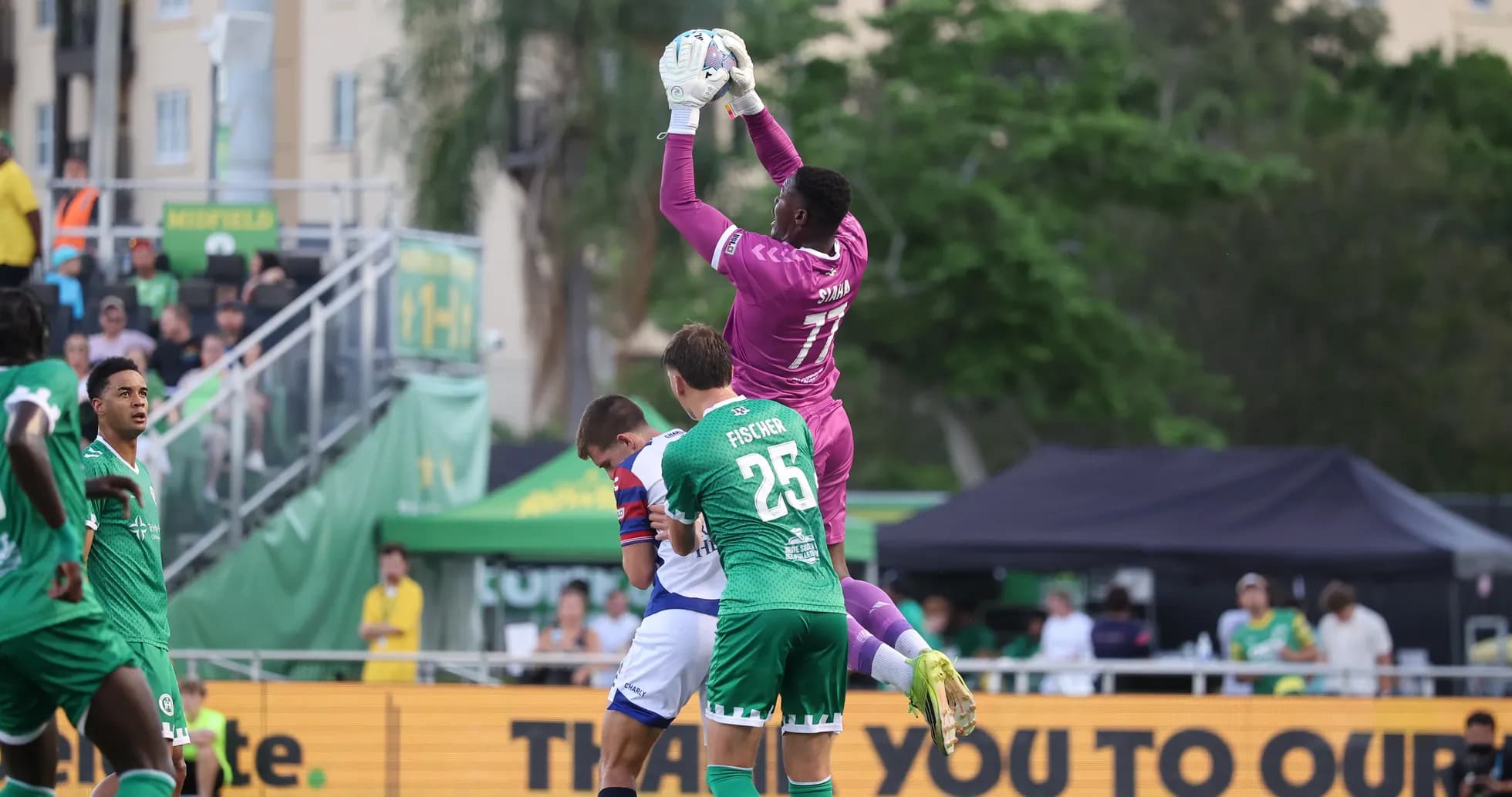 Goalkeeper catching the ball during match
