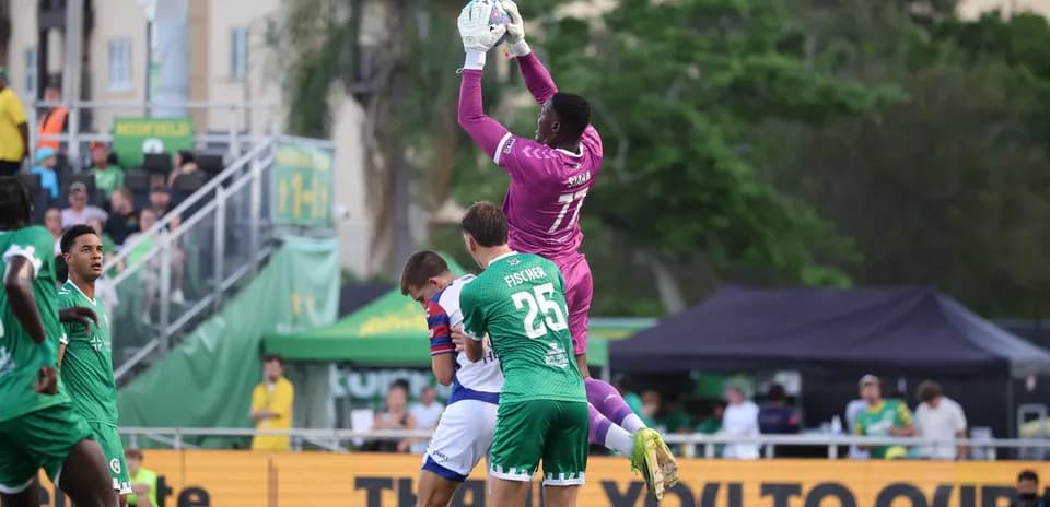 Goalkeeper catching the ball during match