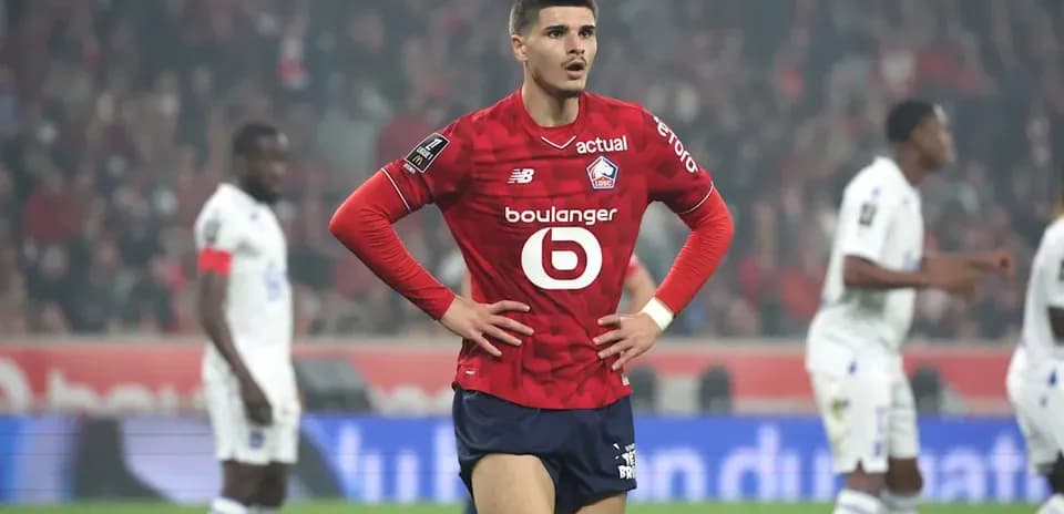 Player in red jersey standing with hands on hips