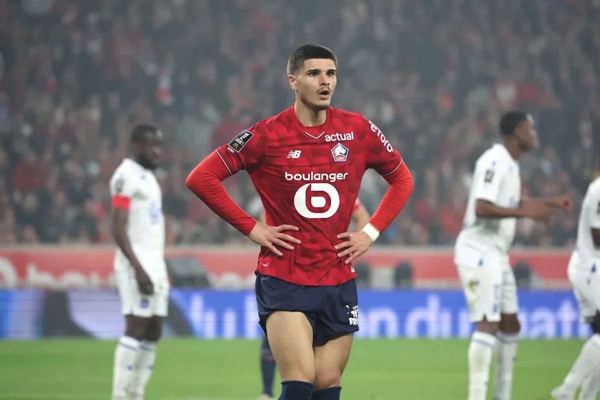 Player in red jersey standing with hands on hips