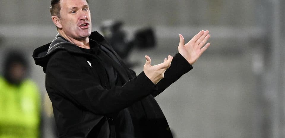 Coach gesturing during a match from the sidelines