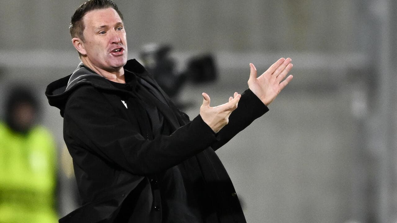 Coach gesturing during a match from the sidelines