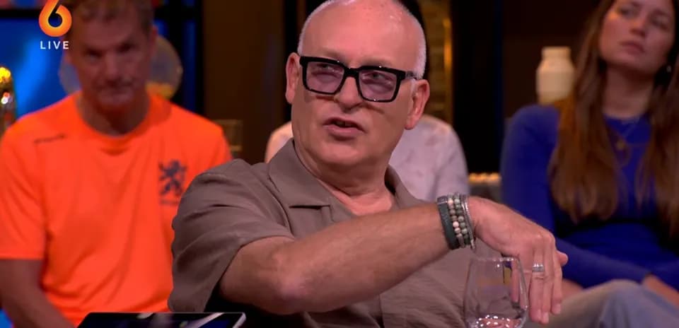 Man gesturing while speaking at a talk show