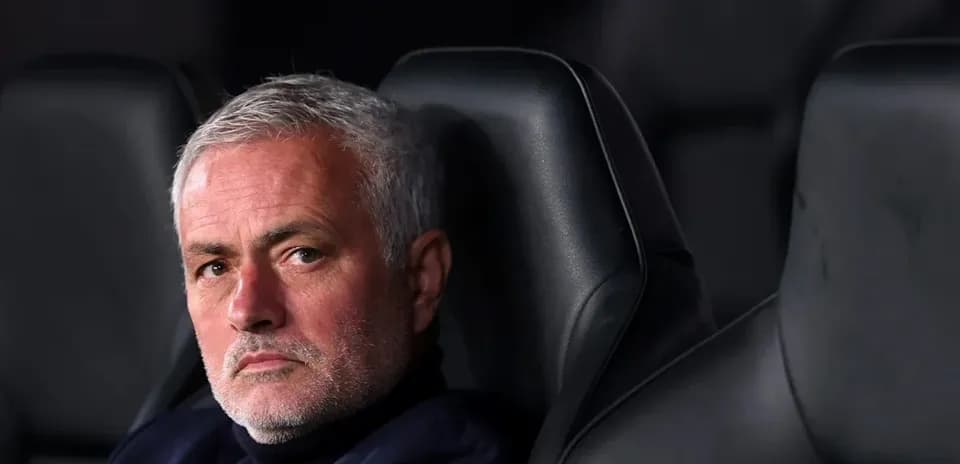 Manager sitting on bench during match