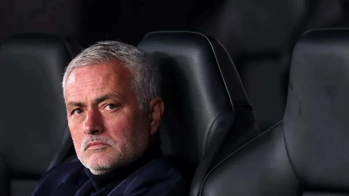 Manager sitting on bench during match