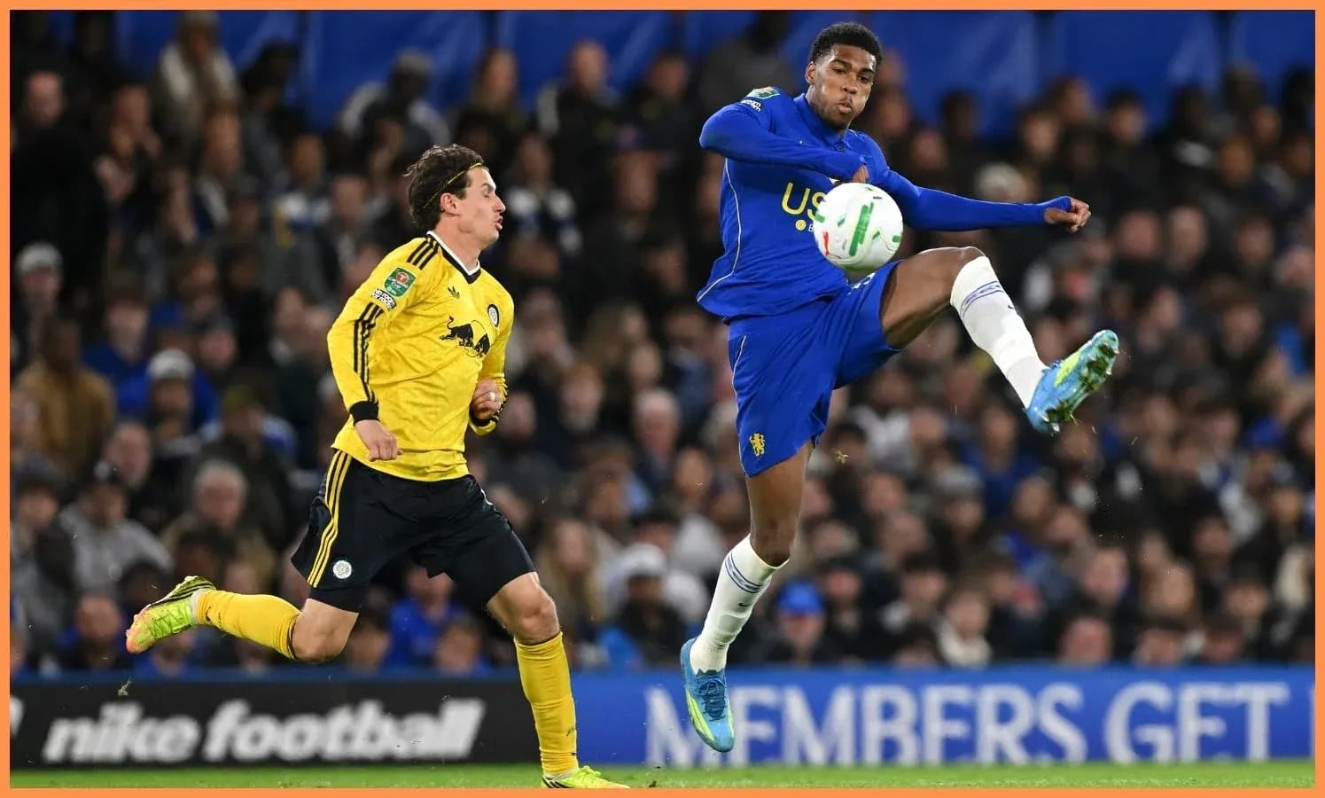 Player in blue kicking ball during match action
