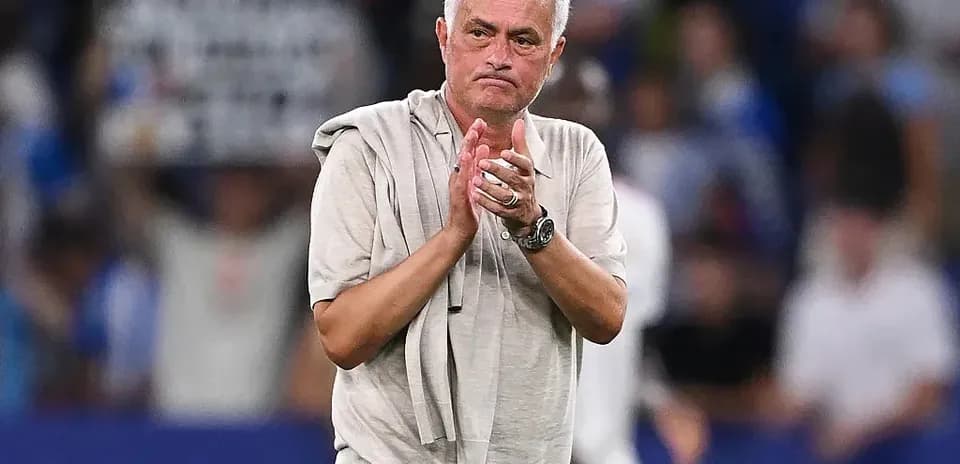 Coach applauding fans after a match